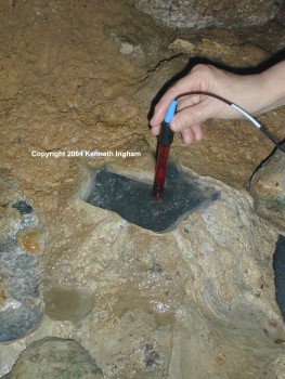 Closeup of taking oxidation-reduction potential readings in highly reducing black mud in a tiny pool called the Teapot pool in Cueva de Villa Luz, Tabasco, Mexico.