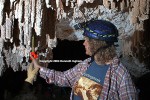 Ghost helping Diana hold the tape measure steady while measuring Pool Fingers hanging from the ceiling of a paleopool in Hidden Cave.